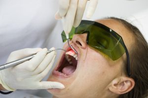 Dentist using Chandler, AZ laser dentistry for periodontal care. 